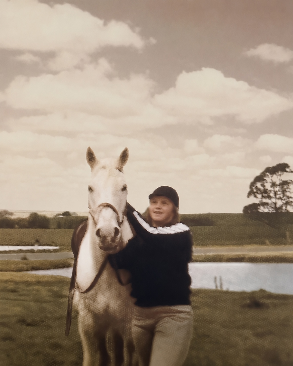 Teenage girl standing with a horse during her years working at a riding school